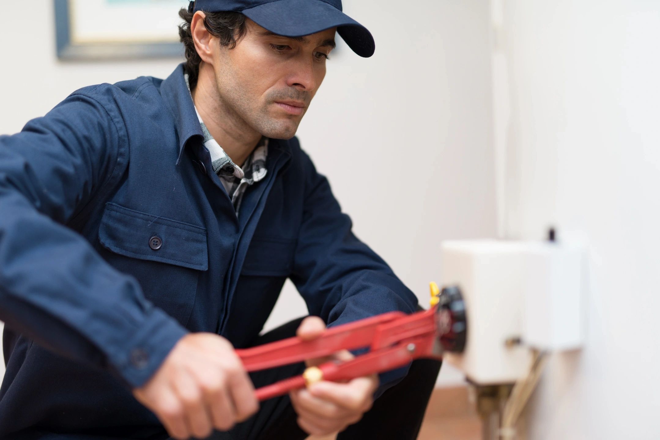 Plumber repairing radiator